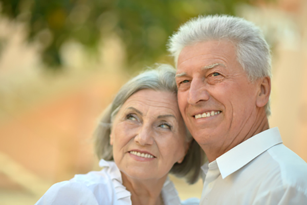 Elderly couple staring at something in the sky while smiling