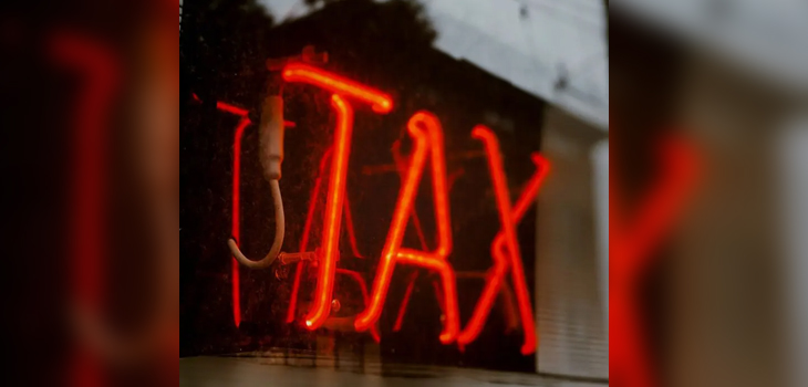 Neon sign reading TAX